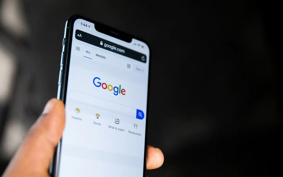 Hand holding a phone open on the Google search page